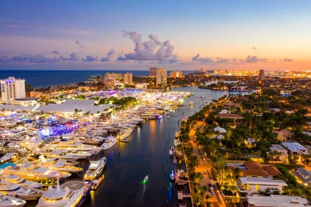 Aerial photo of Fort Lauderdale waterways right after sunset, where the city lights are starting to show. 